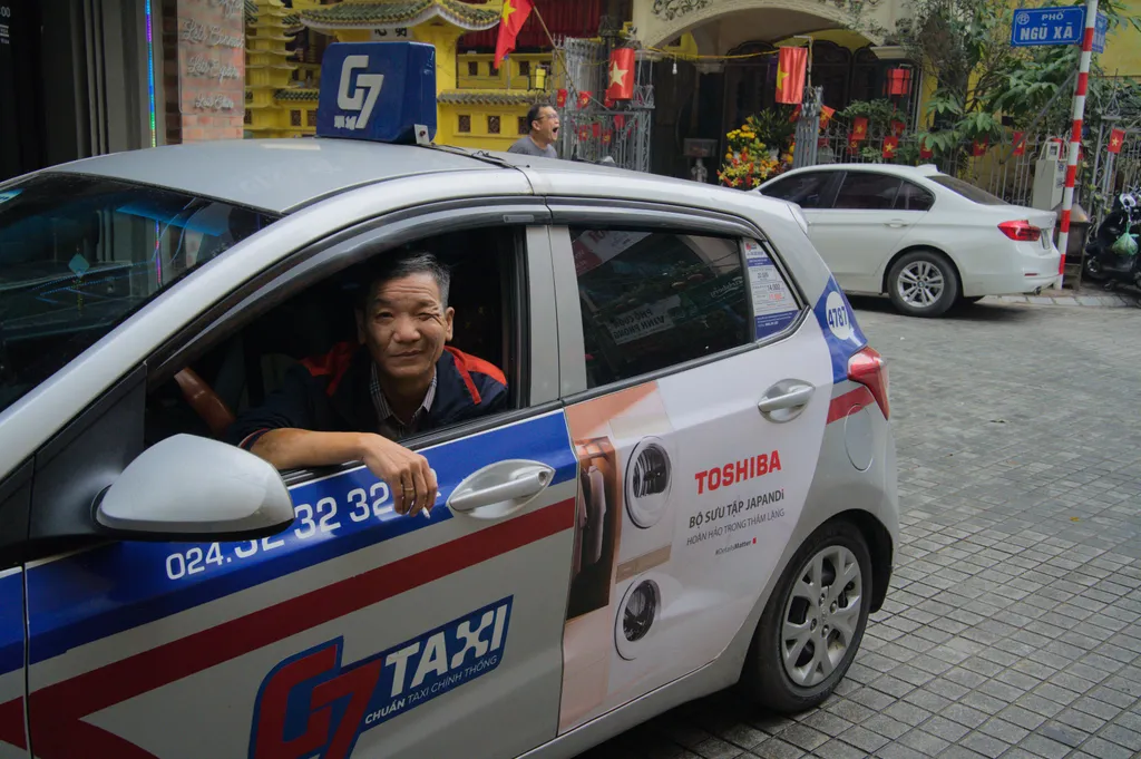 Taxi driver winking as I take his portrait