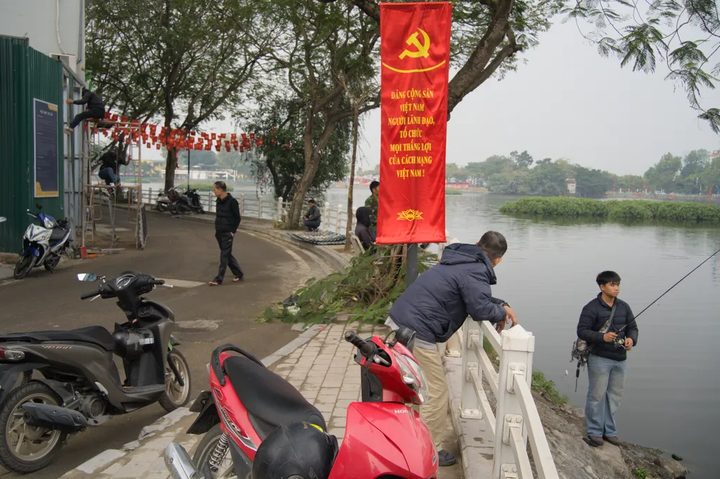 Layered scene by the Trúc Bạch Lake