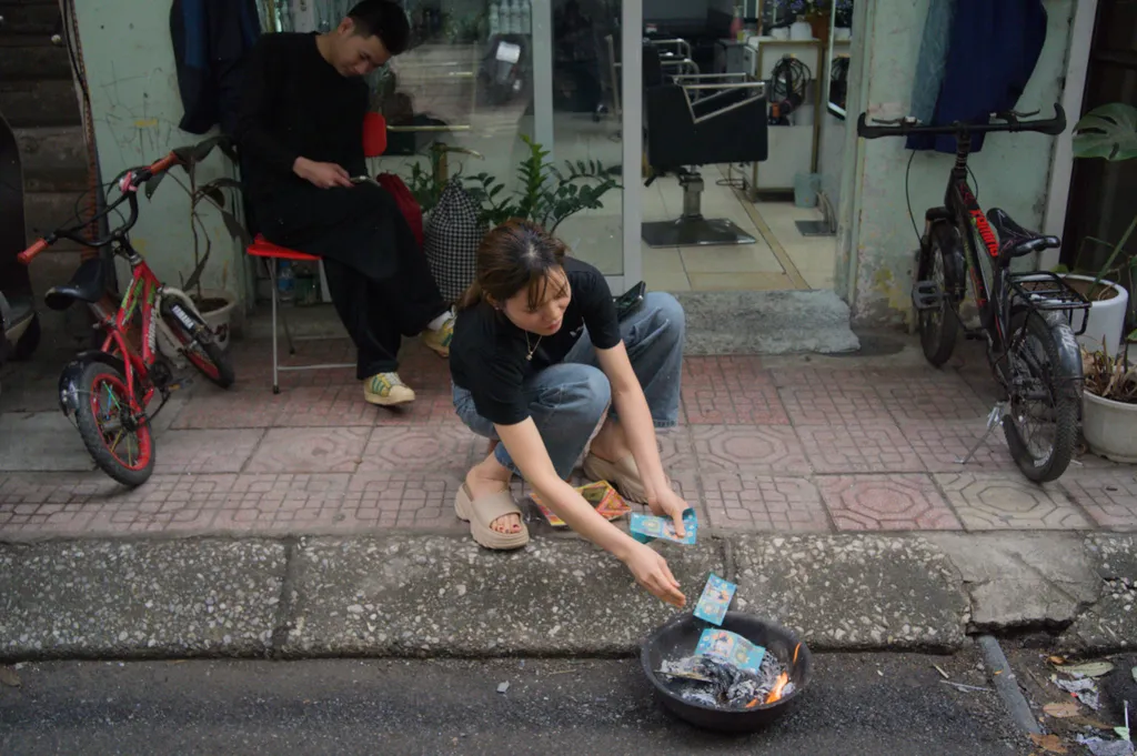 Traditional burning of fake money in front of a business